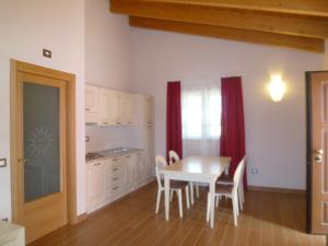 a kitchen and dining room with a table and chairs at Relais Villa Giulia in Bastia Umbra