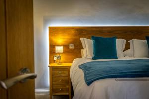 a bedroom with a large bed with a wooden headboard at Brecks Farm - The Parlour in York