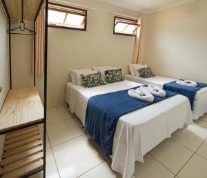 מיטה או מיטות בחדר ב-Village Funchal, Lençóis