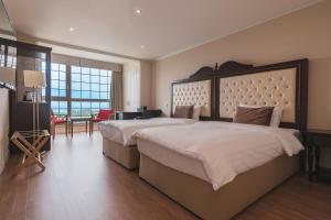 Postel nebo postele na pokoji v ubytování Aria Hotel