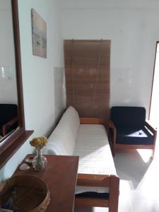 a couch in a room with a table and a chair at Apartment Božava - Nena in Božava
