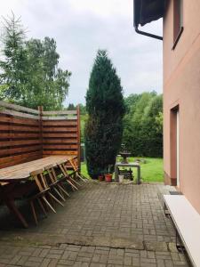 a wooden bench sitting on a brick patio at Na Červené louce relax 2 in Cheb