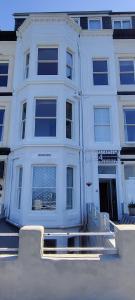 a white apartment building with a large window at Areawest in Scarborough