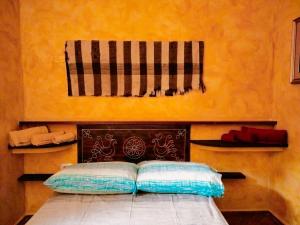 a bedroom with a bed with a blanket on it at Casa Rustica in Dorgali