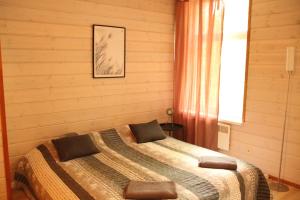 a bedroom with two beds and a window at Tientaus 1 Apartments in Imatra