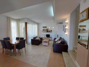 a living room with a couch and a table at Fantastic Sea View Sun village Byala in Byala