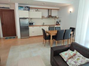 a living room and kitchen with a couch and a table at Fantastic Sea View Sun village Byala in Byala