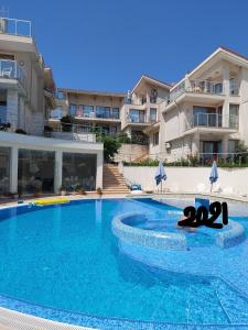 a swimming pool in front of a building at Fantastic Sea View Sun village Byala in Byala