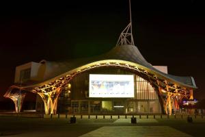 a large building with a large screen in front of it at night at Mignon Studio au coeur de Metz (unenuitametz) in Metz