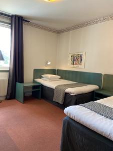 Postel nebo postele na pokoji v ubytování Hotell Älvdalen