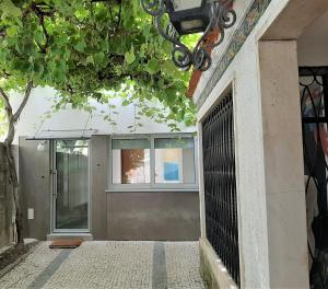 a entrance to a building with a gate at Casa das Camélias Garden Guesthouse in Aveiro