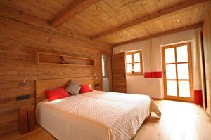 a bedroom with a bed in a wooden room at Almliesl UTTE-652 in Uttendorf