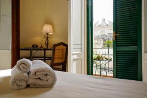 Postel nebo postele na pokoji v ubytování B&B I sei volti Lecce