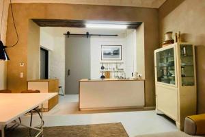a kitchen with a table and a counter in a room at Wunderschöne Ladenwohnung in Kreuzberg in Berlin +12 photos