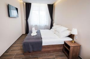 Postel nebo postele na pokoji v ubytování MP hotel