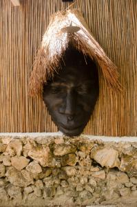 a statue of a man with a hat on a wall at Fragata Island House in Cartagena de Indias