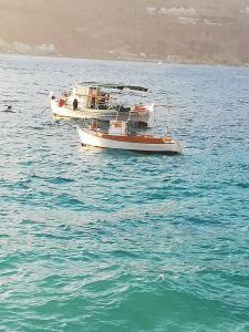 two boats floating on the water in the ocean at TRADITIONAL HOUSE ALEPIS IN AREOPOLIS in Areopoli