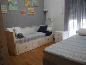 a room with two beds and a couch in it at Larisa, Park view apartment in Larisa