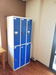 a row of blue lockers in a room at Albergue Buen Camino in Navarrete