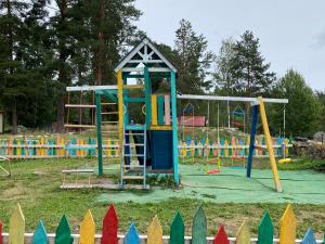 a playground with a slide and a swing at Эко-хутор "Ряйсяля-Райский Сад" in Mel'nikovo