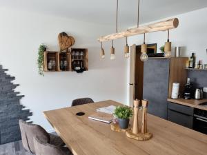 a wooden table in a kitchen with a dining room at Ferienwohnung Schanzenblick in Winterberg