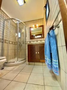 a bathroom with a shower and a sink and a mirror at Maresia Holiday House in Caleta de Sebo