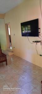 a living room with a flat screen tv on the wall at 3 Bedroom Apartment in westerrn Tobago in Maryʼs Hill