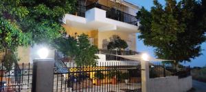 a white building with two lights in front of it at ARETI 3 in Petalidi