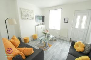 a living room with a couch and a glass table at Bond Street in Ipswich