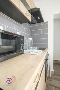 a kitchen with a counter top with a microwave at Bond Street in Ipswich