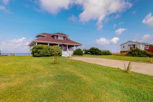 a house sitting on top of a lush green field at Reel Living #3-AV in Avon