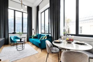 a living room with a blue couch and a table at Bob W Duo Lofts in Tartu