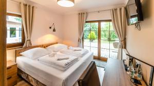 Posteľ alebo postele v izbe v ubytovaní Apartamenty Kapitańskie