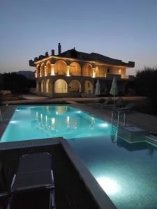 a large swimming pool in front of a building at Villa Penelope in Kalpaki