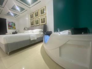 a bathroom with a sink and a bed at MUSE Boutique Hotel in Enugu