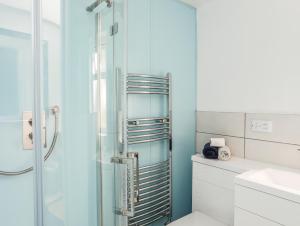 a bathroom with a shower and a sink at Bodlasan Groes House in Holyhead +28 photos