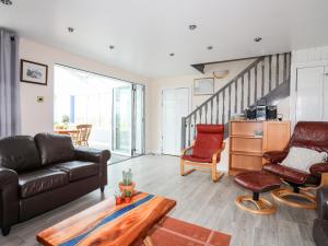 a living room with a couch and a table at Bodlasan Groes Cottage in Holyhead
