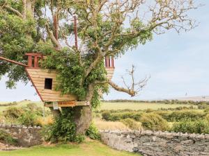 a tree house in a tree at Bodlasan Groes Cottage in Holyhead