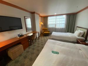 Postel nebo postele na pokoji v ubytování Hotel International Changwon