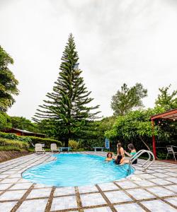 a group of people sitting in a swimming pool at Cabañas La Pradera in Monteverde Costa Rica
