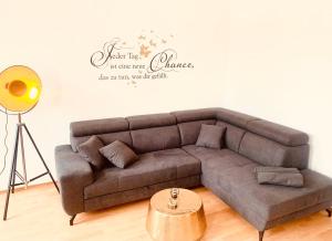 a living room with a couch and a sign on the wall at Domblick in Erfurt