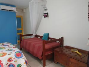 a bedroom with two beds and a dresser at Douceur du Sud in Sainte-Anne