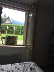 a bedroom with a window looking out at a yard at Appartment tourmalet in Campan