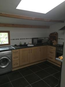 a kitchen with a washer and dryer in it at Appartment tourmalet in Campan
