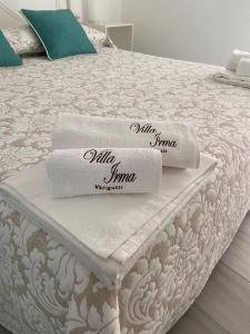 two towels sitting on top of a bed at VILLA IRMA in Varigotti