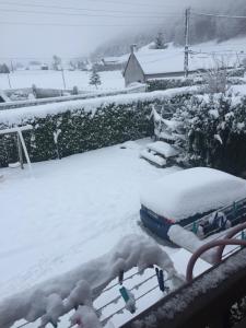 a yard covered in snow with a table at Appartment tourmalet in Campan