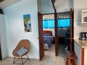 a kitchen with a door leading to a bedroom with a bed at Cabañas el Cerrito 7 in Coquimbo