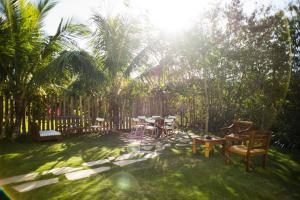 a patio with tables and chairs in a yard at Pousada Vila da Praia in Maricá +45 photos