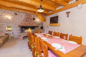 una sala da pranzo con un lungo tavolo e un camino di Vintage Kuzina a Poljica