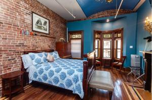 1 dormitorio con cama y pared de ladrillo en Northern Lights Mansion en Nueva York